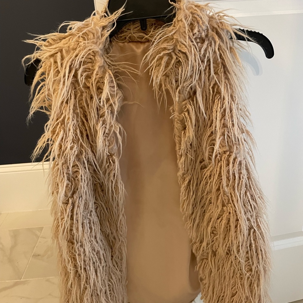 Chic lined vest. Long hair look. Great for in between seasons.